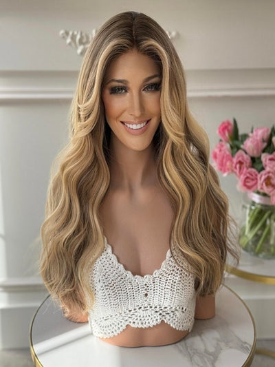 Long wavy honey blond wig made from 100% Eastern European human hair, with a lace front. Medical Wigs Femperial
